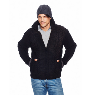 A man wearing a black, handmade Cable Jacket w/ Brass Zipper and beanie.