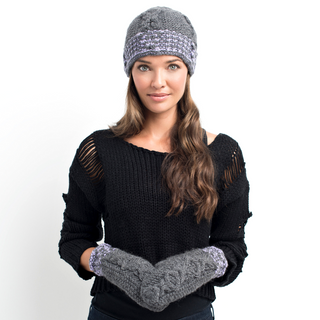 A woman wearing a black sweater with ripped details on the sleeves, a gray knitted hat, and XOXO Fingerless Gloves with Flap featuring a 100% wool fleece lining, standing against a white background.