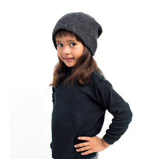 A little girl wearing a black beanie, jeans, and carrying The Depp Slouch.
