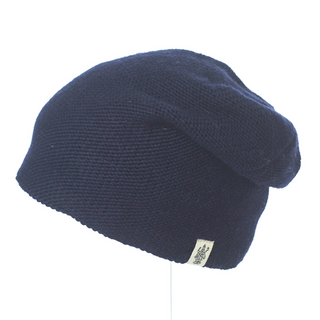 A navy knit beanie, The Depp Slouch, durable and comfortable, on a mannequin.