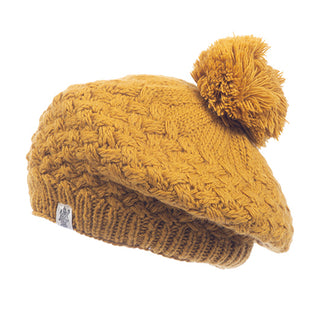 A handmade mustard wool Bliss Beret with a pom-pom.