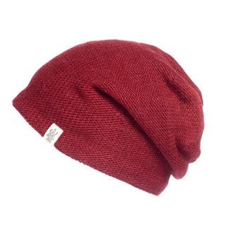 A red knit Depp Slouch on a white background, perfect for adding a pop of color to your skincare routine.