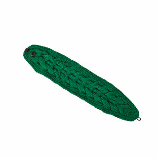 A green knitted cable stitch Soho Headband with Elastic Button Closure and a loop on one end, handmade in Nepal.