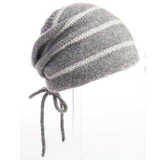 A grey and white striped wool Stripe Pouch Slouch Hat with fleece lining on a mannequin.