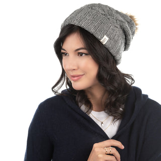 A woman wearing a Hope Slouch with a pom pom.