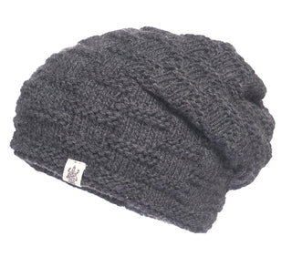 A grey knitted Elevated Slouch Hat with a logo on it, perfect for pairing with women's activewear.