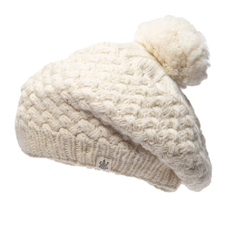 A handmade white wool knit beanie with a pom pom, known as the Bliss Beret.