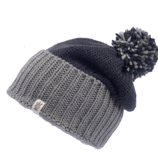 A Masha pom slouch hat with a pom-pom on top.