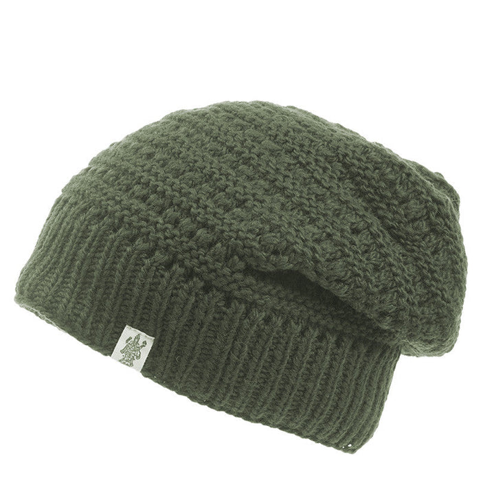 The Hand Knit Boho Slouch is displayed against a white background. This olive green beanie features a slouchy design, a ribbed band, and a small rectangular tag attached to the side of the band.