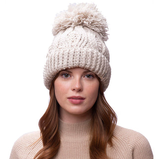 A woman wearing a Big pom rib fold hat with a pom pom.