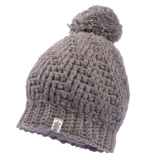 A grey merino wool Swirl pom beanie.