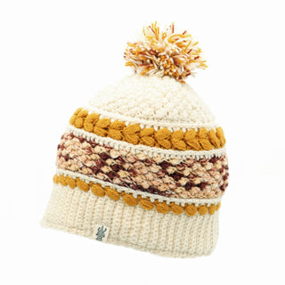 A knitted Bubble pom pom hat on a white background.