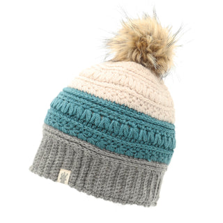 A beanie hat with a Stripe Flower Fur Pom Pom on it.