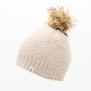 A beige Moss fur pom pom hat.