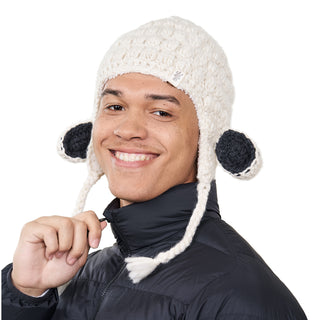 A person wearing a Lamb Ears hat smiles at the camera.