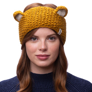 A woman wearing a knitted bear ears headband.