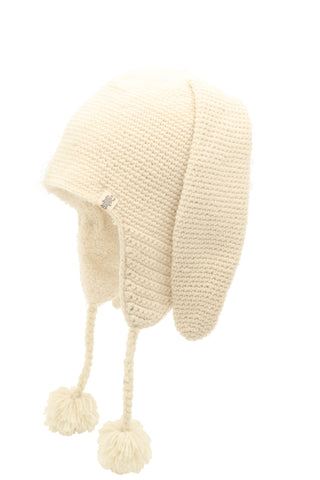 A cream-colored, knitted Long Ear puppy hat with pompom ties on a white background.