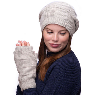 A woman wearing a beanie and checkered handwarmers.