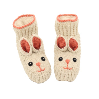 A pair of knitted rabbit slippers on a white background.