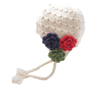 Handmade in Nepal, Crochet 3 Flower Earflap baby hat with multicolored flower appliqués and a braided tassel on a white background.