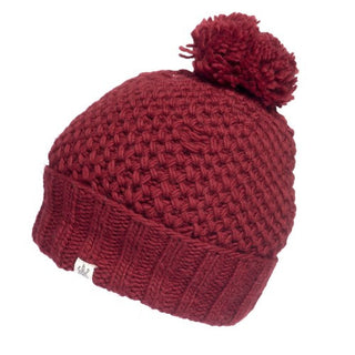 A handmade Rutland Beanie in burgundy merino wool with a pom pom.