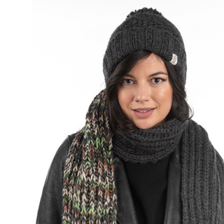 A woman wearing a handmade merino wool Rutland Beanie and scarf.