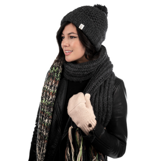 A woman wearing a handmade Pewter Rutland Beanie, scarf, and gloves.