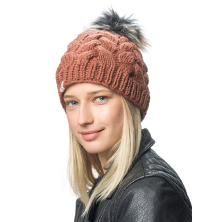 A woman wearing a Boheme Cable Beanie with Faux Fur Pom.