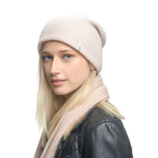 A blonde woman wearing a Troubadour Rib Fold Beanie and scarf.