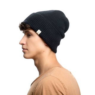 A man wearing a Troubadour Rib Fold Beanie.