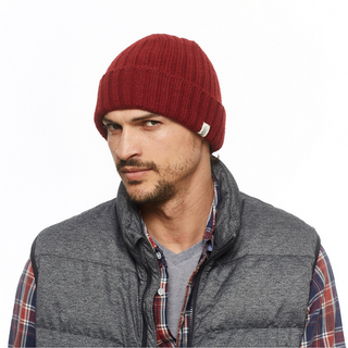A man wearing a red Clyde Rib Fold Cap beanie and gray vest.