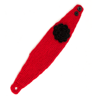 A red Detachable Flower Headband w/ Button, crocheted with a black flower applique and two buttons, photographed against a white background, handmade in Nepal.