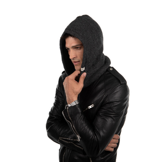 A man wearing a black leather jacket and a Hero Hood hoodie.