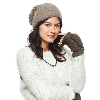 A woman wearing a knit hat and Lucy In the Sky Fingerless Gloves w/ Flap posing with her hand on her cheek.