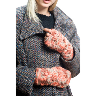 A woman wearing a durable coat and gloves, carrying a Multi Color Flower Crochet Handwarmers backpack.