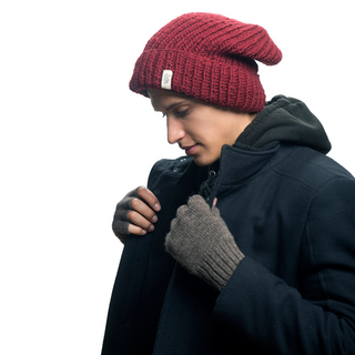 A man wearing a burgundy beanie and Striped and Solid Fingerless Gloves for a winter look.