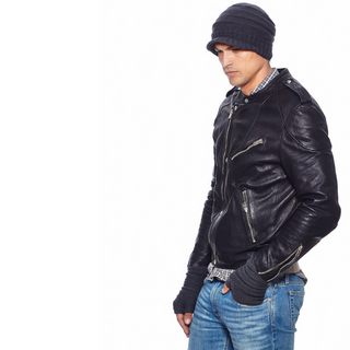 A man in a black leather jacket and a beanie with Reverse Step Handwarmers.
