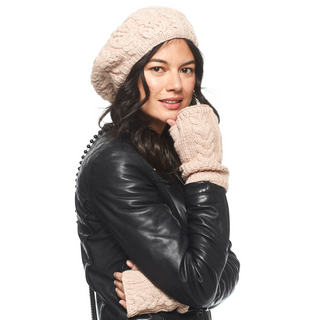 A woman wearing an organic leather jacket, a beanie, and Cable Handwarmers.