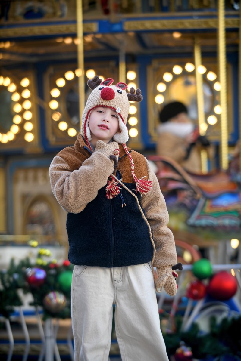 Child in a lion knit hat