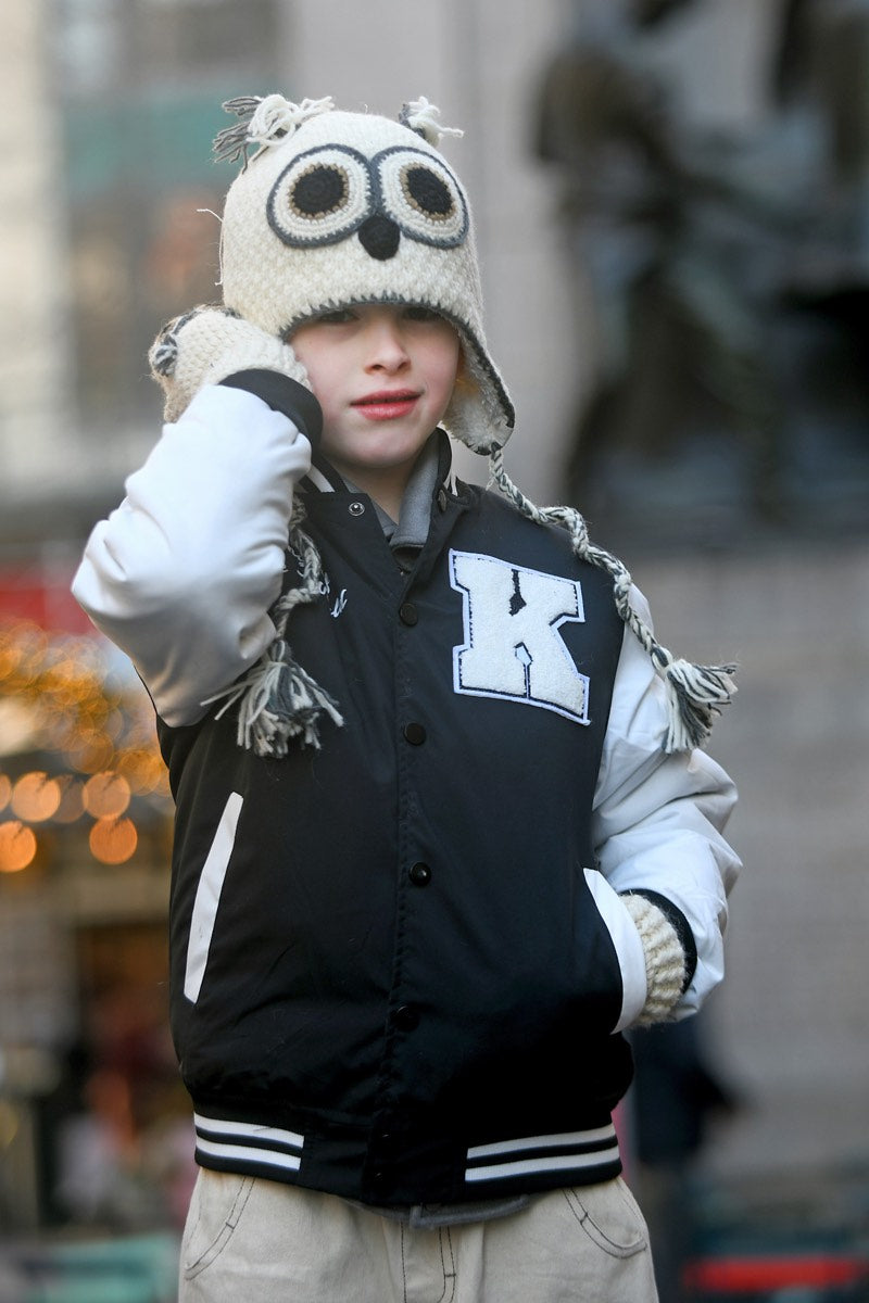 Child in an owl knit hat