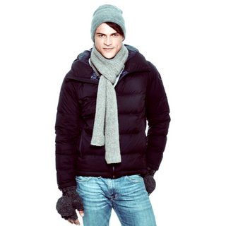 A young man in a down jacket and a handmade Roam Scarf.
