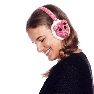 A woman wearing pink and white Pig Earmuffs.
