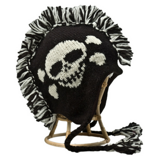 A black and white knitted Skull Mohawk hat with a skull detail and a wool Mohawk on top, featuring ear flaps and tassels, displayed on a stand.