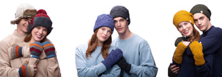 Three couples wear winter hats and mittens in various colors, standing close together and smiling, against a white background.