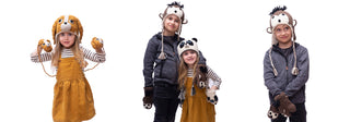 Three children wearing animal-themed hats and gloves pose against a white background. One child wears a lion set, another wears a monkey set, and one wears a panda set.