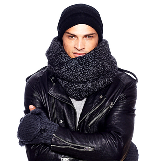 A man in a black leather jacket and a handmade CozyChic® Barefoot Dreams® Sherpa Lined Infinity Scarf.
