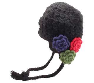 A black Crochet 3 Flower Earflap hat, handmade in Nepal and decorated with multicolored wool flowers on a white background.
