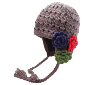 A brown Crochet 3 Flower Earflap hat, handmade in Nepal, adorned with colorful flowers on the side, isolated on a white background.