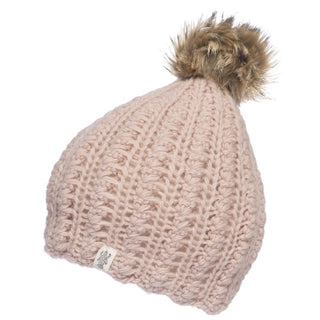 A pale pink Layla Beanie, made from merino wool with a fluffy faux fur pom-pom at the top, featuring a scallop knit pattern.