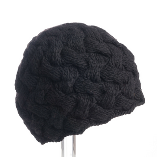 Handmade in Nepal, the Holden Beanie displayed on a stand against a white background.
